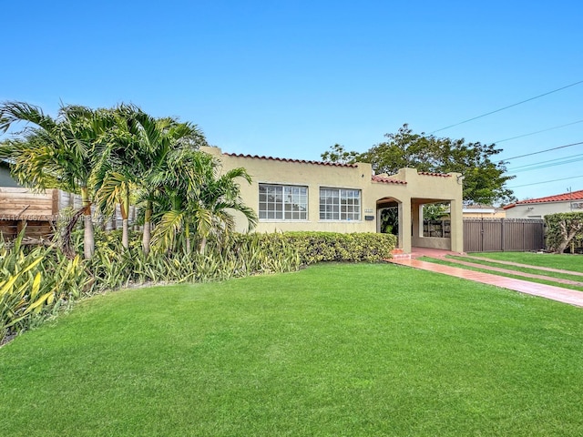 mediterranean / spanish-style house with a front yard