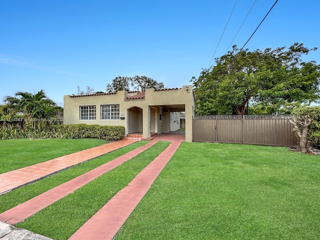 mediterranean / spanish-style house featuring a front lawn