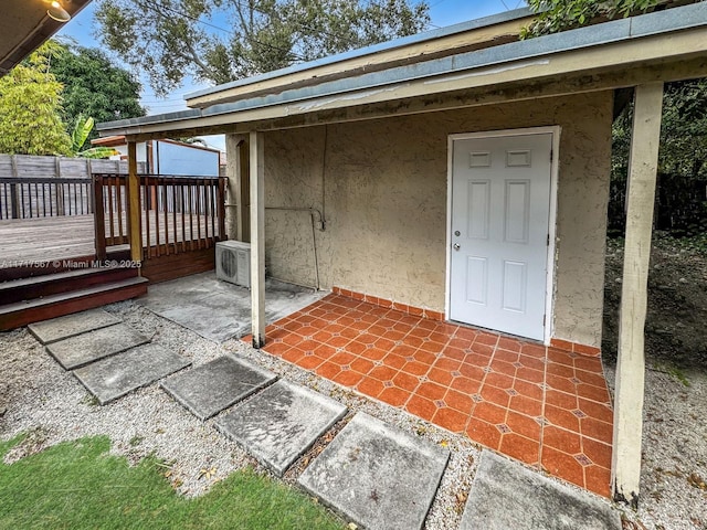 exterior space with ac unit and a deck