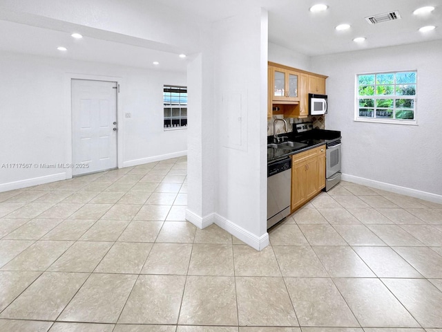 kitchen with light tile patterned flooring, sink, and appliances with stainless steel finishes