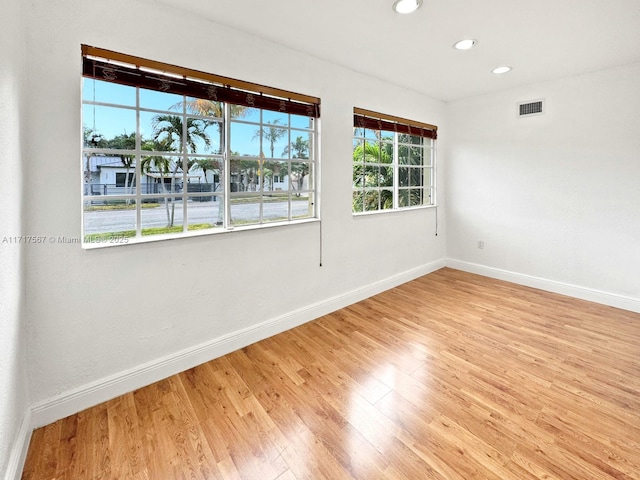 unfurnished room with light wood-type flooring