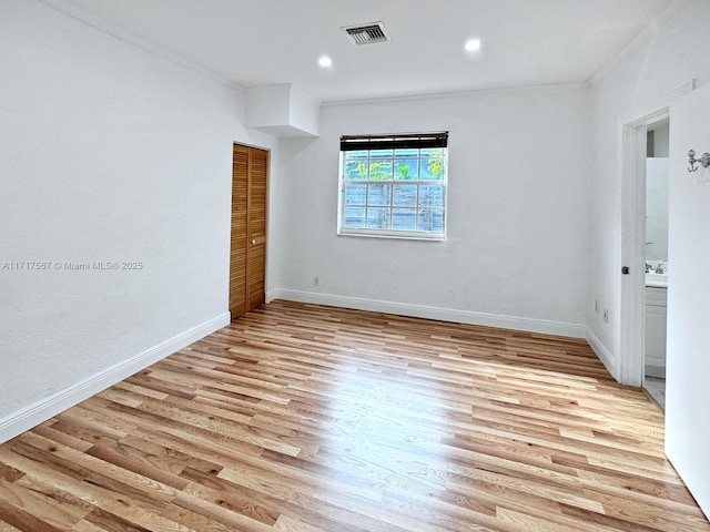 spare room with light hardwood / wood-style floors and ornamental molding