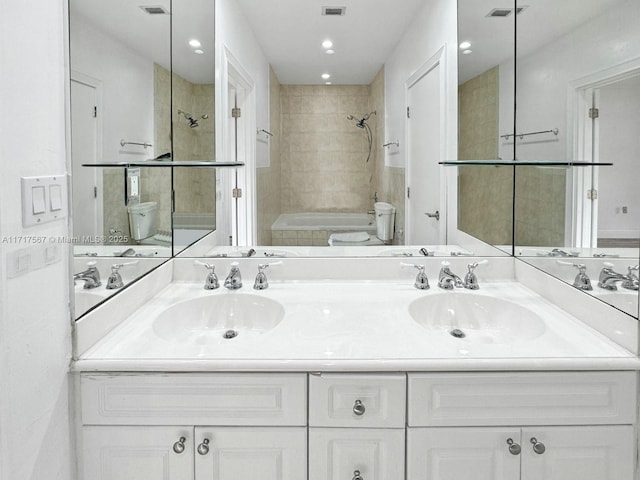 full bathroom featuring vanity, toilet, and tiled shower / bath