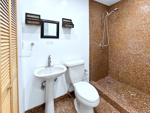 bathroom featuring tile patterned floors, toilet, and a shower