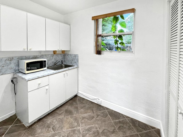 kitchen with white cabinets and sink