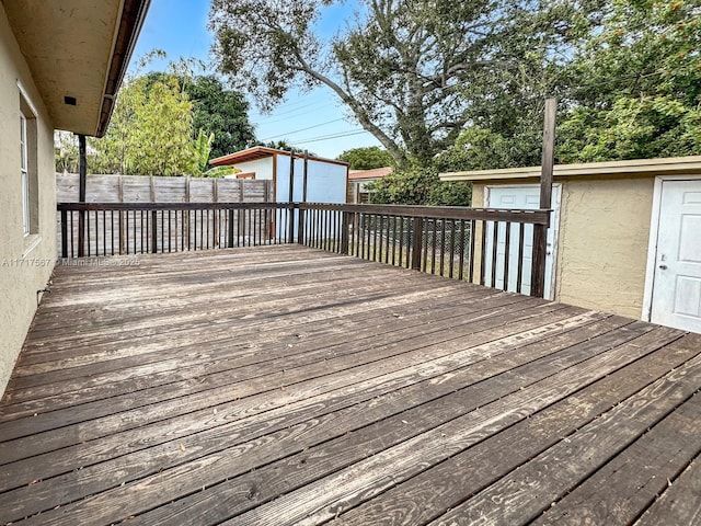 wooden terrace featuring a storage shed