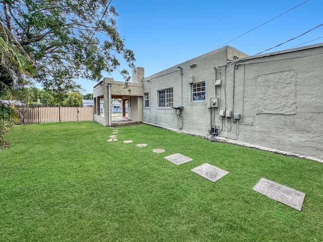 back of property featuring a lawn