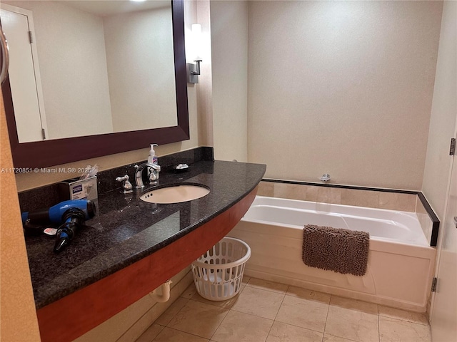 bathroom featuring sink, a bath, and tile patterned flooring