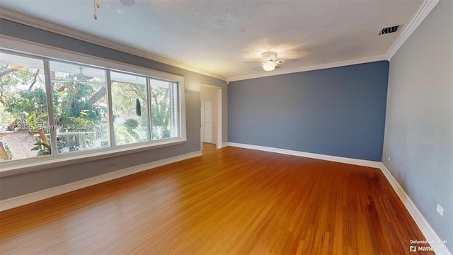 unfurnished room with hardwood / wood-style flooring, crown molding, and ceiling fan