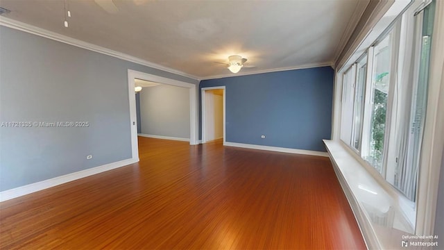 empty room with crown molding, ceiling fan, and hardwood / wood-style floors