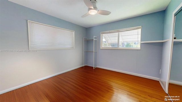 empty room with hardwood / wood-style floors and ceiling fan