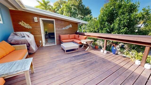 wooden terrace with an outdoor hangout area