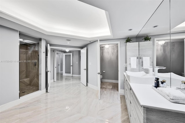 bathroom with vanity, toilet, and a tile shower