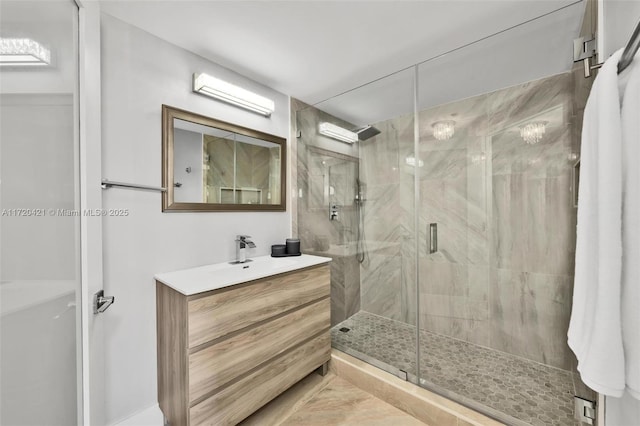 bathroom with walk in shower and vanity