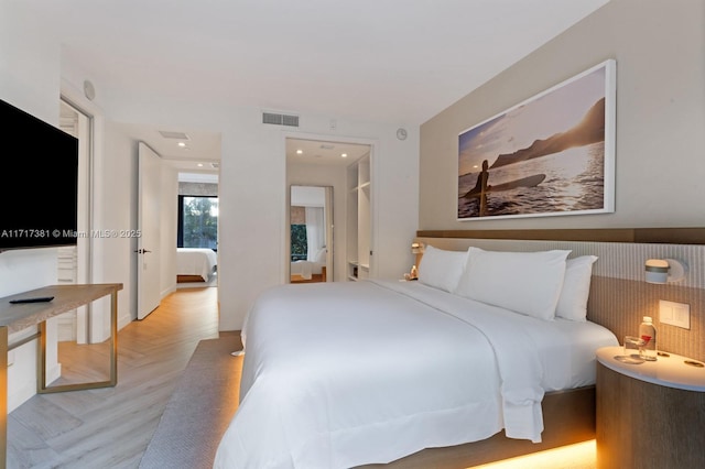 bedroom featuring light parquet flooring