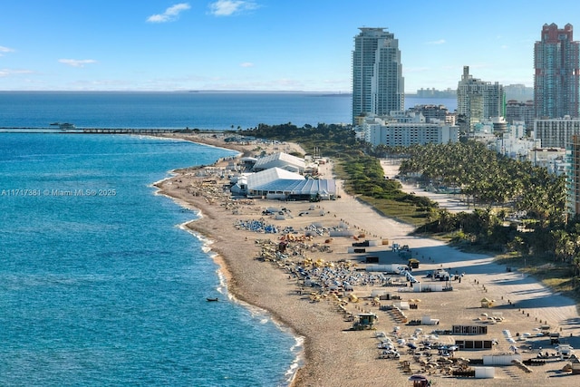 birds eye view of property with a beach view and a water view