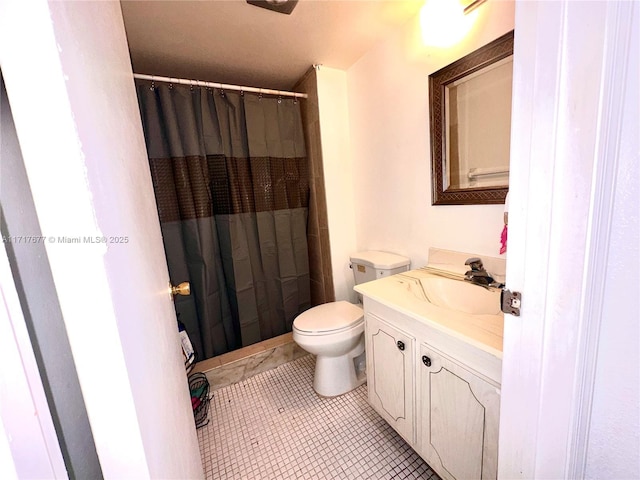 bathroom featuring tile patterned floors, curtained shower, vanity, and toilet