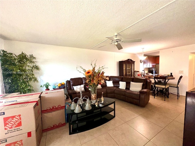 tiled living room featuring a textured ceiling and ceiling fan