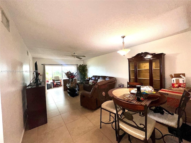 dining space with a textured ceiling and ceiling fan