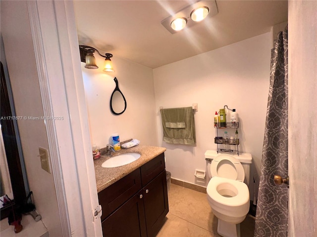 bathroom with tile patterned flooring, vanity, and toilet