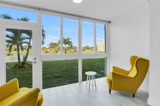 sunroom / solarium with a water view