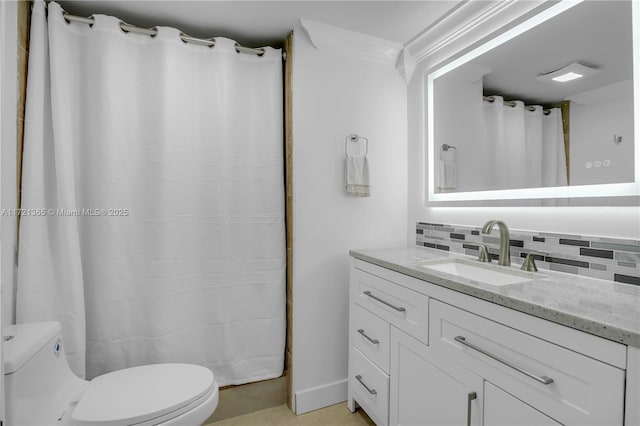 bathroom featuring vanity, crown molding, tile patterned flooring, decorative backsplash, and toilet