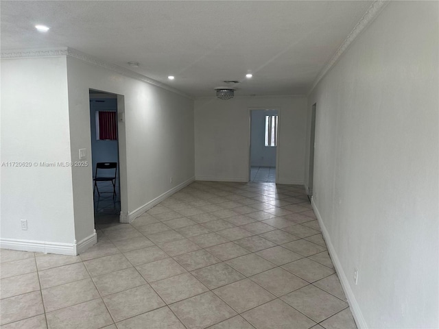 tiled spare room with ornamental molding