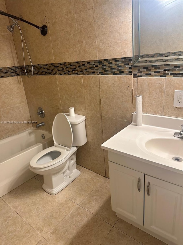 full bathroom with toilet, tiled shower / bath, tile patterned floors, and vanity