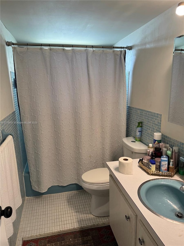 full bathroom featuring tile patterned floors, vanity, shower / tub combo, tile walls, and toilet