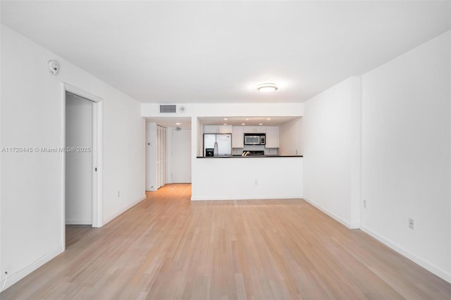 unfurnished living room featuring light wood-type flooring