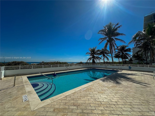 view of swimming pool with a patio area