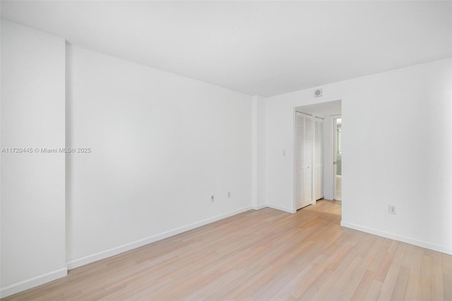 spare room featuring light hardwood / wood-style floors