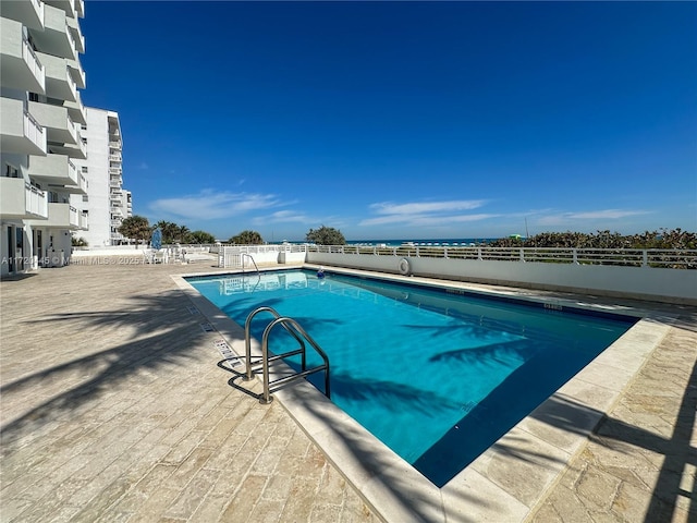 view of swimming pool with a patio area