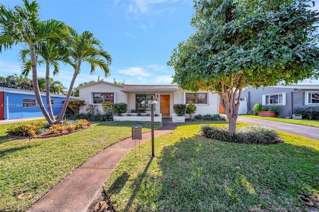 ranch-style home with a front lawn