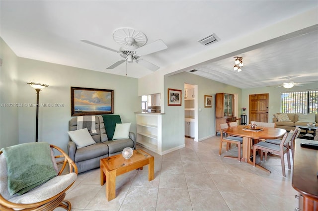 tiled living room with ceiling fan