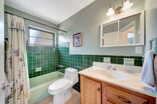 full bathroom with tile patterned floors, toilet, shower / tub combo, tile walls, and vanity