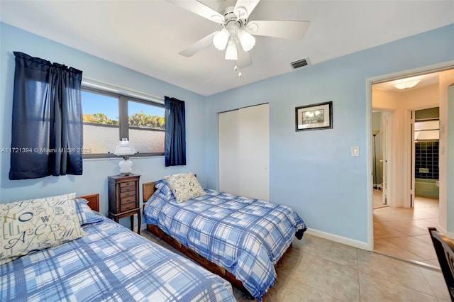 bedroom featuring light tile patterned floors, a closet, and ceiling fan