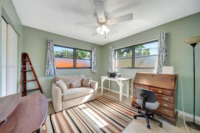 office area featuring ceiling fan, light tile patterned floors, and a healthy amount of sunlight