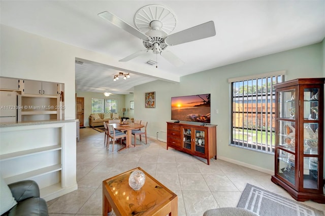 tiled living room featuring lofted ceiling and ceiling fan