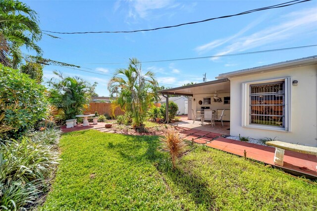 view of yard featuring a patio and ceiling fan