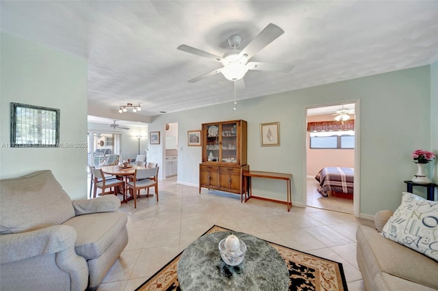 tiled living room with ceiling fan