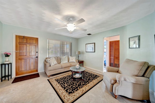 living room with ceiling fan and light tile patterned floors