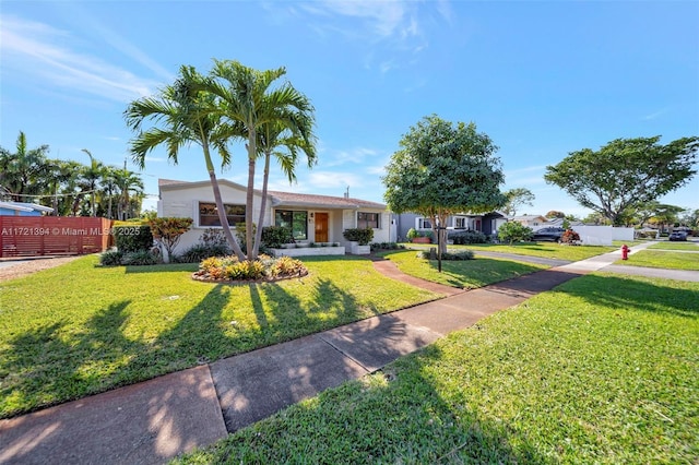 ranch-style home featuring a front lawn