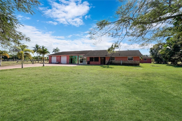 single story home featuring a garage and a front yard