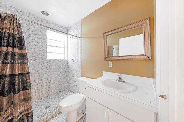 bathroom featuring a shower with curtain, vanity, and toilet