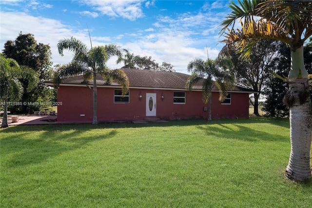 rear view of house featuring a lawn