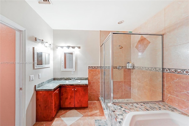 bathroom with tile patterned flooring, vanity, and an enclosed shower