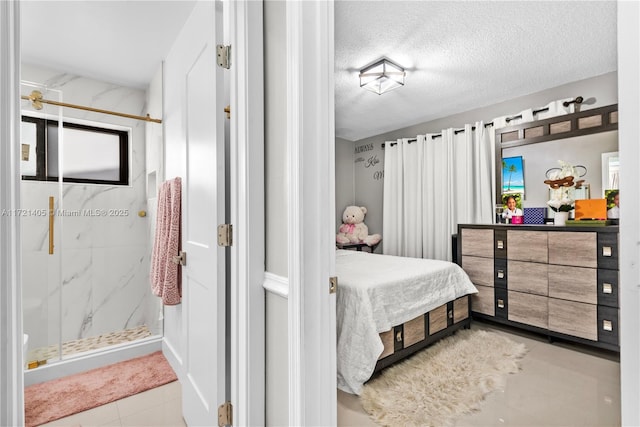 bedroom featuring light tile patterned floors and a textured ceiling