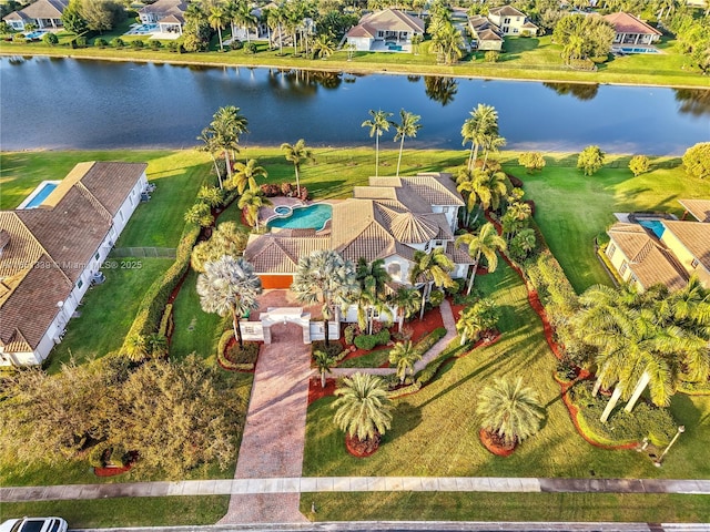 drone / aerial view with a water view and a residential view