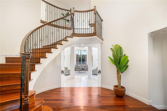 14403 S Jockey Cir S, Davie, FL 33330 - stairway featuring wood finished floors and a towering ceiling